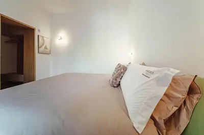 a bedroom with a large white bed with avertisementvertisementosateosateosateosateosate at Seasicily Boutique Apartment in Palermo