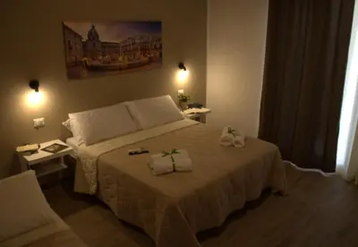 a bedroom with a bed with two towels on it at Casa Vacanze Cipriano in Casteldaccia