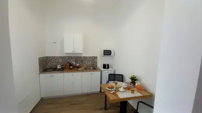 a kitchen with a table with food and drinks on it at Casa Vacanze Cipriano in Casteldaccia