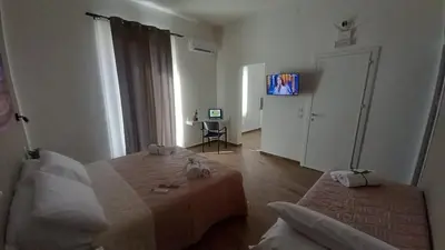 a room with a bed and a television in it at Casa Vacanze Cipriano in Casteldaccia