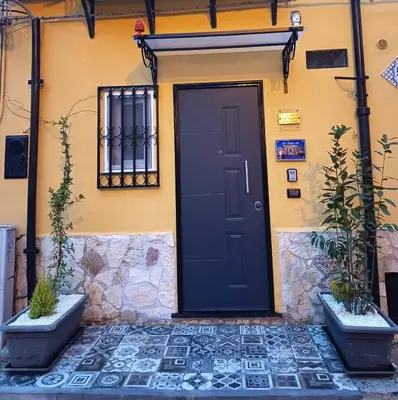 a black door on the side of a house at La Suite del Viaggiatore in Palermo