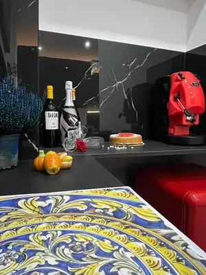 a kitchen with a counter with two bottles of wine at La Suite del Viaggiatore in Palermo