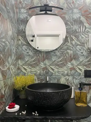 a bathroom with a black sink and a mirror at La Suite del Viaggiatore in Palermo