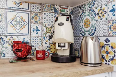a kitchen counter with a blender on a table with tiles at CastroViva House in Palermo