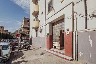 a stop sign on a city street with a building at CastroViva House in Palermo