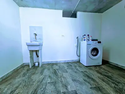 a laundry room with a washing machine and a sink at Sunset in Santa Flavia