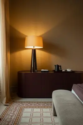 a lamp sitting on a dresser in a bedroom at Palazzo Balsamo Boutique Hotel in Palermo
