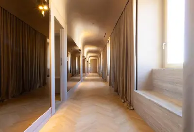 a corridor of a building with wooden floors and ceilings at Palazzo Balsamo Boutique Hotel in Palermo