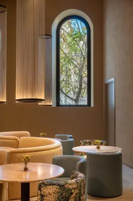 a room with tables and chairs and a window at Palazzo Balsamo Boutique Hotel in Palermo