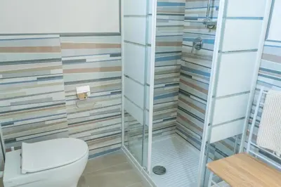 a bathroom with a toilet and a shower at Casetta Giardinetto in Altavilla Milicia