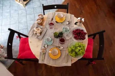 a table with plates of food and grapes on it at Casa Duci - Historic center in Palermo
