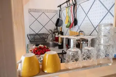 a kitchen counter with yellow containers on a counter top at Casa Duci - Historic center in Palermo