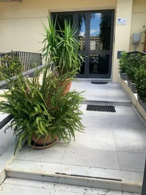 a porch with potted plants in front of a door at Girasole Marino in Palermo