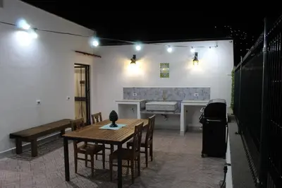 a patio with a table and chairs and a bench at Esperia Home in Palermo