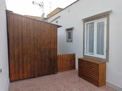 a wooden gate in a room with a window at Esperia Home in Palermo