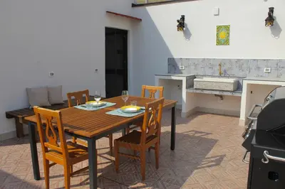 a dining room with a wooden table and chairs at Esperia Home in Palermo