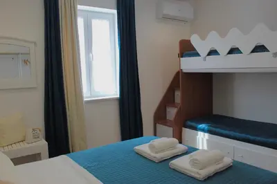 a bedroom with a bunk bed with two white towels at Esperia Home in Palermo