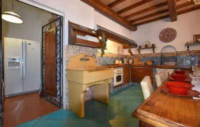 a kitchen with a sink and a table with bowls at Cozy Apartment In Trappeto With Wifi in Trappeto