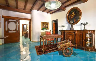 a room filled with furniture and a carriage on a tile floor at Cozy Apartment In Trappeto With Wifi in Trappeto