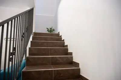 a stairway with brown steps and a plant at Villa Verde - Nature Holiday Home in Carini