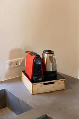 a coffee maker sitting on a stand on a counter at Cathedral Apartment - Stay in Palermo in Palermo