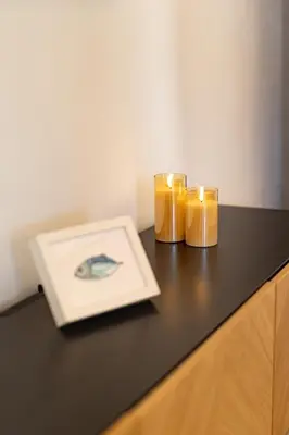 a table with two candles and a plate on it at Cathedral Apartment - Stay in Palermo in Palermo