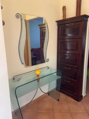 a glass table with a mirror and a dresser at Il Giardino di Seba in Campofelice di Roccella