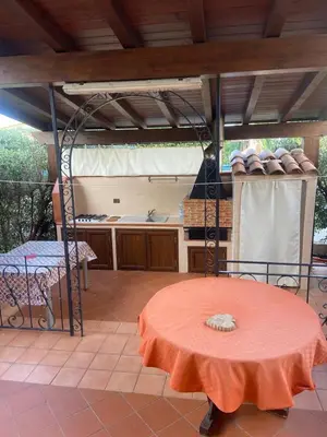 a room with a table and a kitchen with a tableablish at Il Giardino di Seba in Campofelice di Roccella