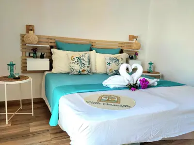a bedroom with a bed with two swans on it at Villa Cerasella - Rustic Sicilian Retreat with Private Pool & Sunset View in Trappeto