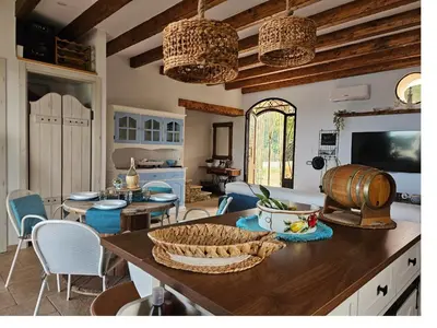 a kitchen with a table with a barrel on it at Villa Cerasella - Rustic Sicilian Retreat with Private Pool & Sunset View in Trappeto