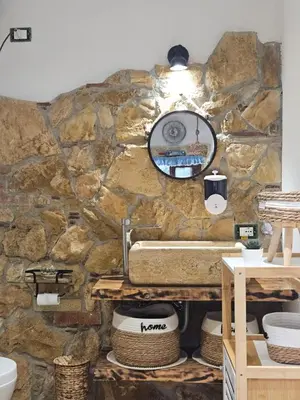 a stone bathroom with a sink and a mirror at Villa Cerasella - Rustic Sicilian Retreat with Private Pool & Sunset View in Trappeto