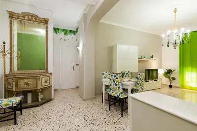 a kitchen and dining room with a table and chairs at Holiday Apartment My House in Palermo
