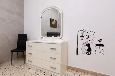a dressing room with a dresser and a mirror at Holiday Apartment My House in Palermo