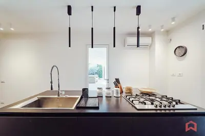 a kitchen with a sink and a stove at Esclusiva Villa con Piscina Privata a Mondello in Palermo