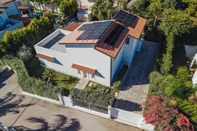 an overhead view of a house with solar panels on the roof at Esclusiva Villa con Piscina Privata a Mondello in Palermo