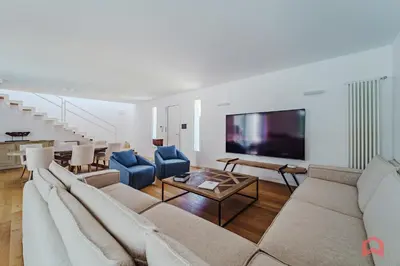 a living room with a couch and a table at Esclusiva Villa con Piscina Privata a Mondello in Palermo