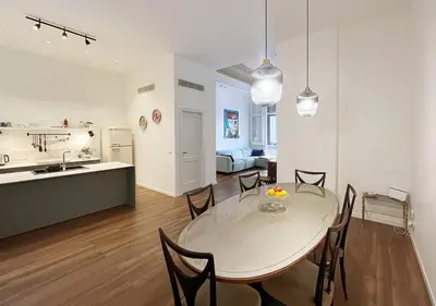 a white kitchen with a sink and a counter top at Solemar Sicilia - Casa Castiglione in Palermo