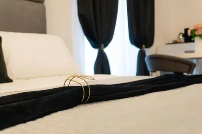 a bedroom with a bed and a tv above a fireplace at Algaria Sicilian Suites in Palermo