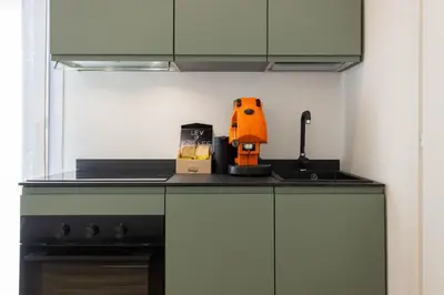a kitchen counter with a juicer on top of it at Donna Lia Apartment in Palermo