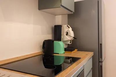 a kitchen with a coffee machine on a counter at Don Federico Apartment in Palermo
