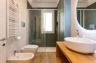 a bathroom with a white sink and a toilet at Don Federico Apartment in Palermo