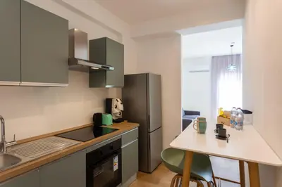 a kitchen with green cabinets and a counter top at Don Federico Apartment in Palermo