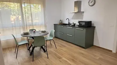a kitchen with a table and chairs in a room at La Casa di Simo in Palermo