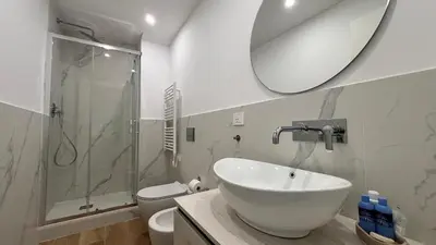 a bathroom with a sink and a shower and a toilet at La Casa di Simo in Palermo