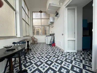 a room with a blue and white tile floor at Cluverio House Apartment in Palermo