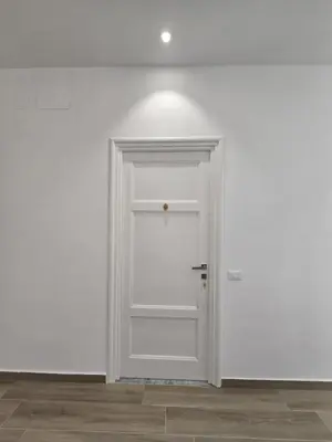 an empty room with a white door in a white wall at GiuAdel casa Palermo in Palermo