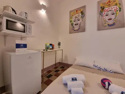 a small living room with a tv and a couch at Donna Emma by Holiday World in Carini