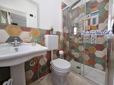 a bathroom with a toilet and a sink and a shower at Donna Emma by Holiday World in Carini