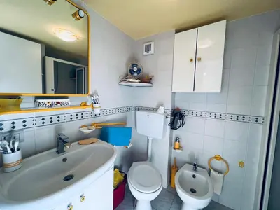 a bathroom with a white sink and a toilet at Casa Vacanza Pinto a 80 mt dal mare in Campofelice di Roccella
