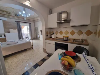 a kitchen with a table with a bowl of fruit on it at Donna Elisa by Holiday World in Carini